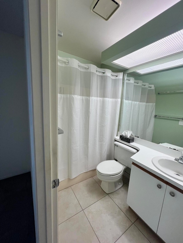 bathroom with tile patterned flooring, vanity, and toilet