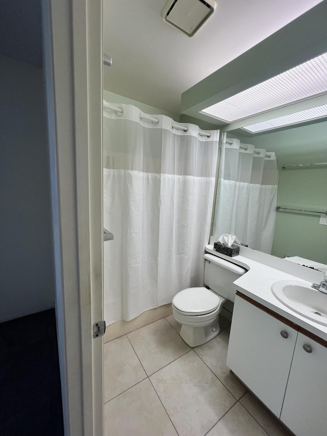 13 Lake Vista Trl Unit 205, Port Saint Lucie, FL 34952 - full bath with toilet, vanity, tile patterned floors, and shower / bathtub combination with curtain