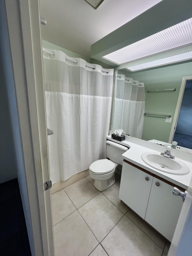 13 Lake Vista Trl Unit 205, Port Saint Lucie, FL 34952 - full bathroom with vanity, toilet, tile patterned floors, and curtained shower