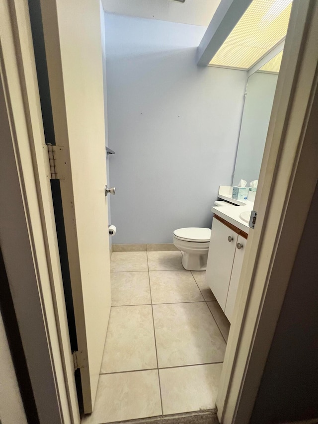 bathroom featuring tile patterned floors, vanity, and toilet