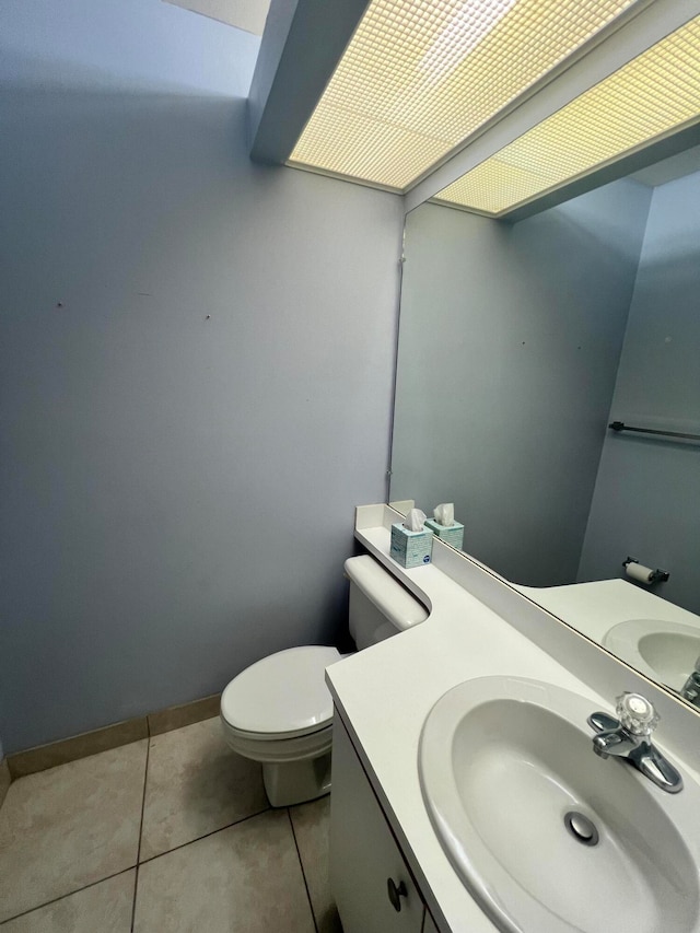 bathroom with tile patterned floors, vanity, and toilet