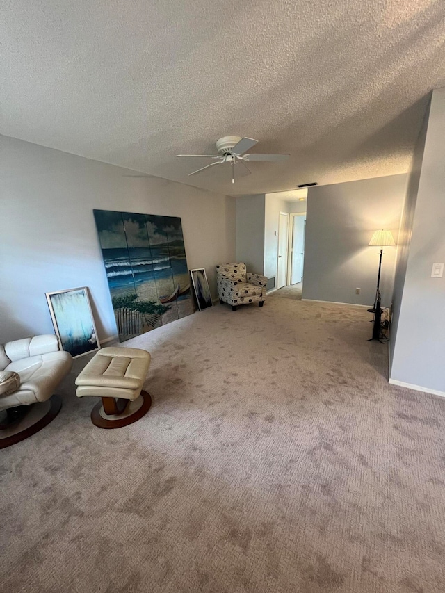 unfurnished room with ceiling fan, carpet, and a textured ceiling