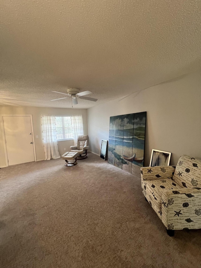 13 Lake Vista Trl Unit 205, Port Saint Lucie, FL 34952 - living area featuring a textured ceiling, carpet flooring, and a ceiling fan