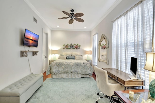 bedroom with ceiling fan, ornamental molding, and hardwood / wood-style flooring