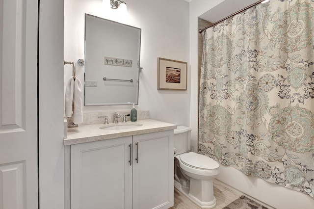 full bathroom with shower / bath combination with curtain, vanity, wood-type flooring, and toilet