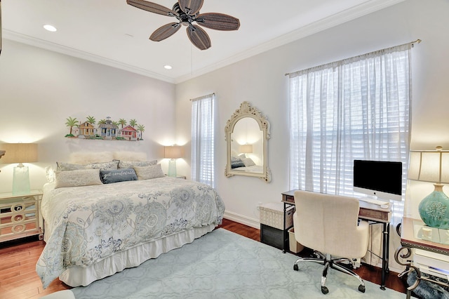 bedroom featuring multiple windows, ceiling fan, wood-type flooring, and ornamental molding