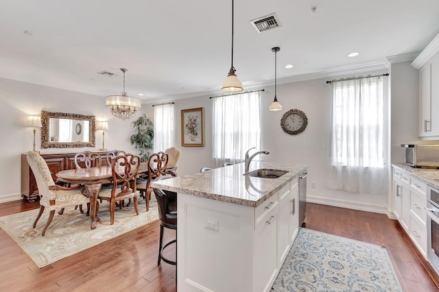 kitchen featuring white cabinetry, sink, and hardwood / wood-style flooring