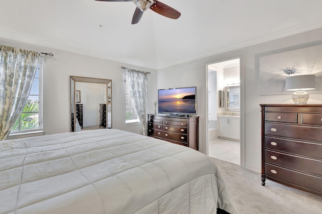 carpeted bedroom with ensuite bathroom, ceiling fan, crown molding, and vaulted ceiling