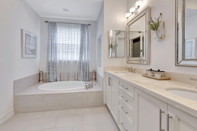 bathroom with tile patterned flooring, vanity, and tiled tub