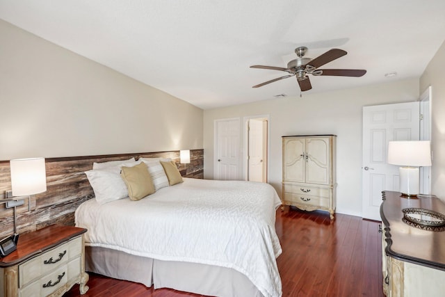 bedroom with dark hardwood / wood-style flooring and ceiling fan