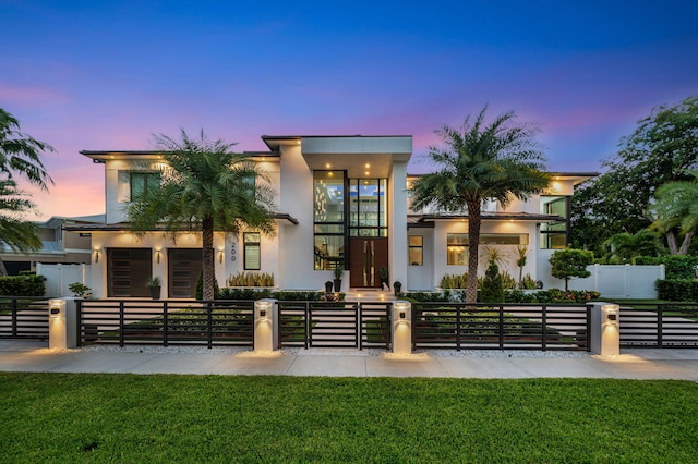 200 NE 6th St, Boca Raton, FL 33432 - contemporary home with a fenced front yard, stucco siding, a front lawn, and a gate