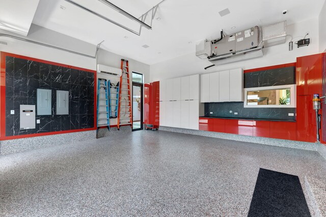 garage featuring a wall mounted AC and electric panel