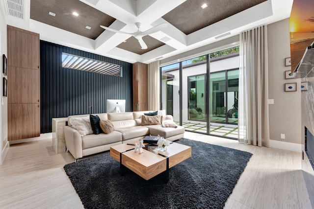 living room with beamed ceiling, coffered ceiling, light hardwood / wood-style flooring, and ceiling fan