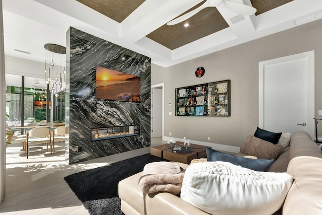 living room with beamed ceiling, wood-type flooring, coffered ceiling, and a fireplace