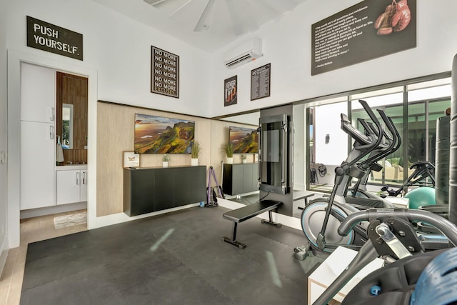 exercise room featuring a wall mounted air conditioner and dark wood-type flooring