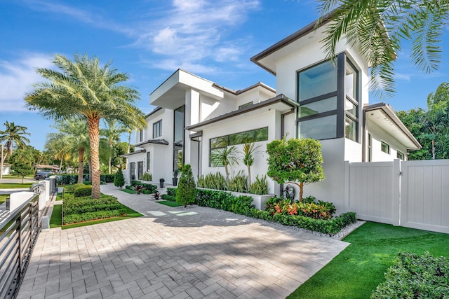 200 NE 6th St, Boca Raton, FL 33432 - view of side of home with a gate, fence, and stucco siding