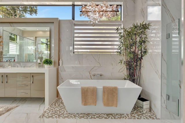 bathroom featuring vanity, a healthy amount of sunlight, independent shower and bath, and tile walls