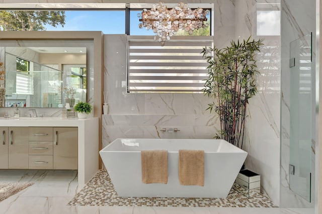 200 NE 6th St, Boca Raton, FL 33432 - full bath featuring a soaking tub, an inviting chandelier, tile walls, and vanity