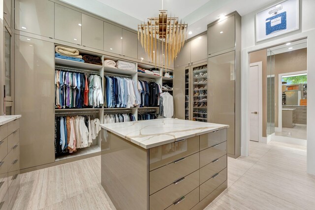 200 NE 6th St, Boca Raton, FL 33432 - walk in closet featuring an inviting chandelier and light tile patterned floors