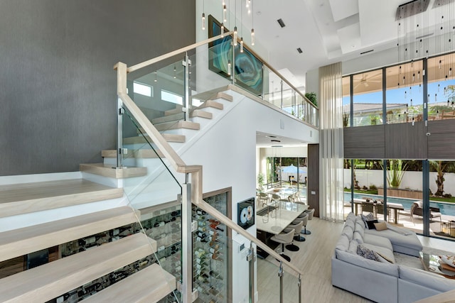 200 NE 6th St, Boca Raton, FL 33432 - stairway featuring a high ceiling and wood finished floors