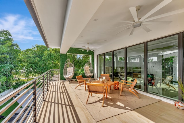 view of patio / terrace featuring ceiling fan and a balcony