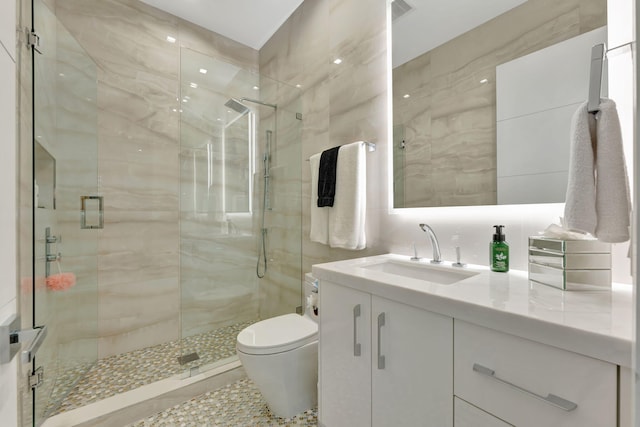 200 NE 6th St, Boca Raton, FL 33432 - full bath with a shower stall, tile walls, vanity, and toilet