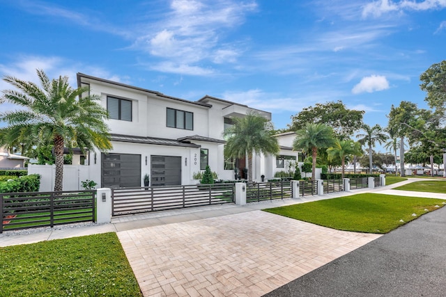 view of front of property with a front yard and a garage