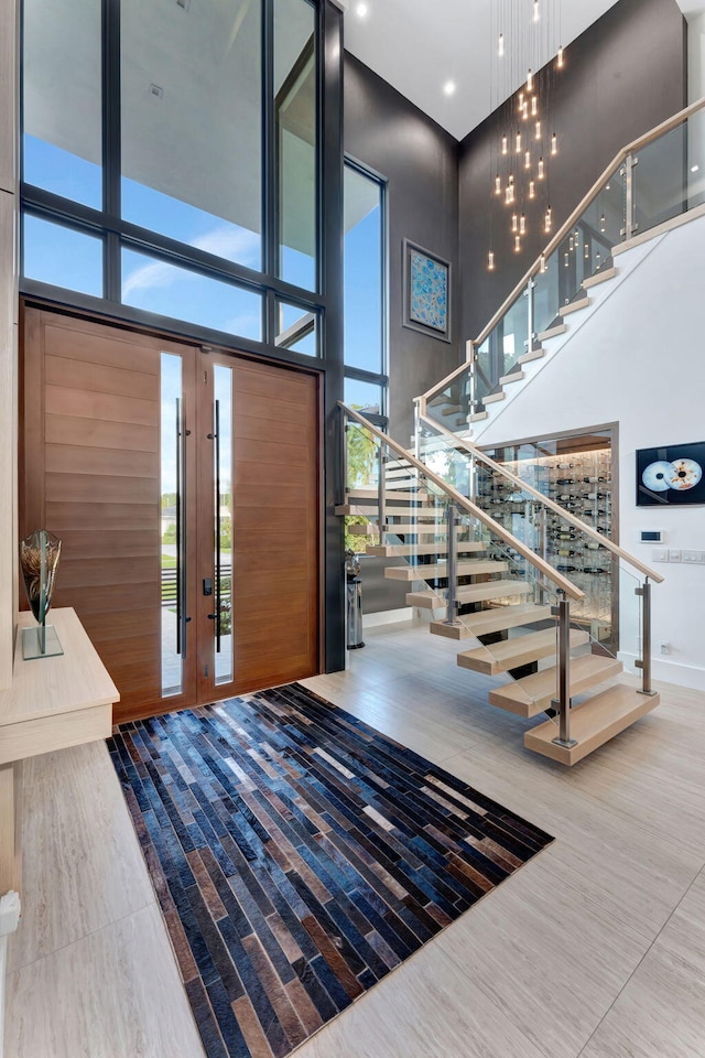 200 NE 6th St, Boca Raton, FL 33432 - foyer with stairway, expansive windows, a towering ceiling, and french doors