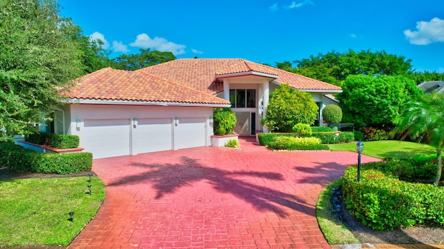 mediterranean / spanish-style home with a garage