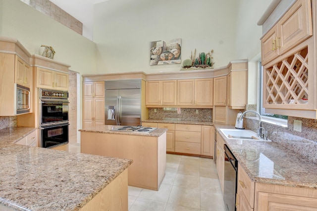 kitchen featuring light brown cabinets, a center island, and appliances with stainless steel finishes