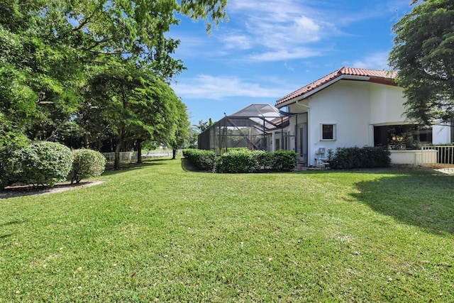 view of yard with glass enclosure