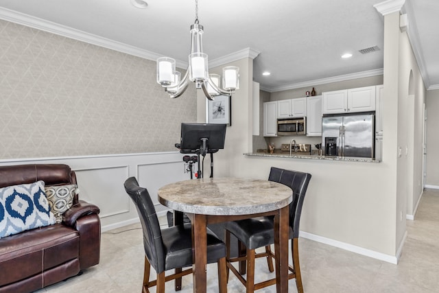 dining room with a chandelier and ornamental molding