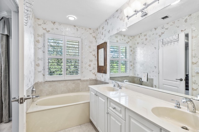 bathroom with vanity, tile patterned floors, and a bathtub