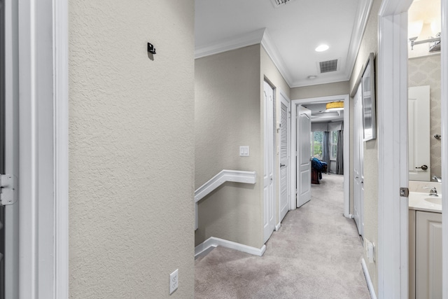 hall with light carpet and crown molding