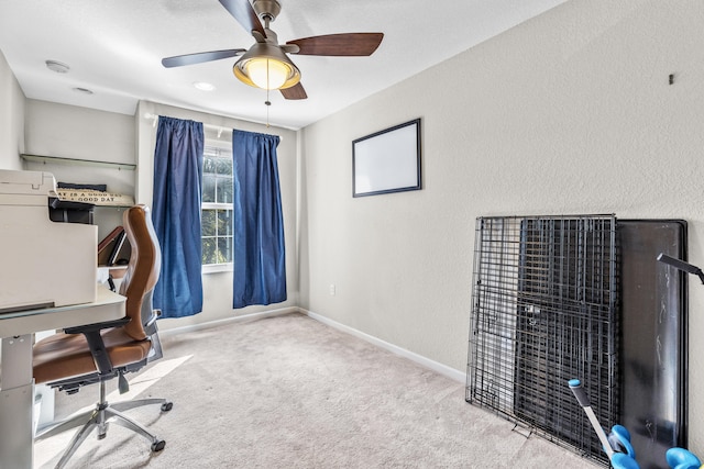 office space with light carpet and ceiling fan