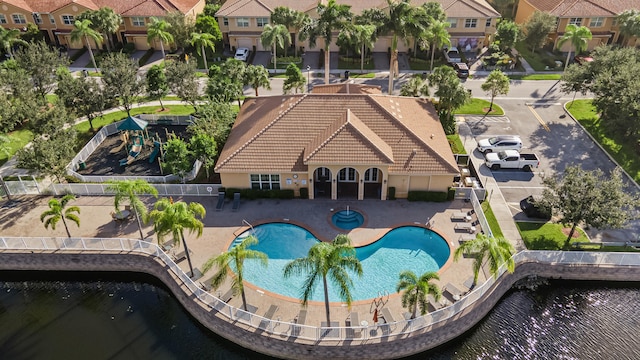 view of swimming pool featuring a water view and a patio area