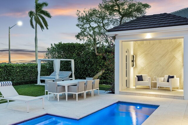 pool featuring outdoor dining area and a patio