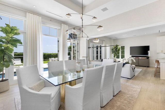 dining room featuring a chandelier and light hardwood / wood-style floors