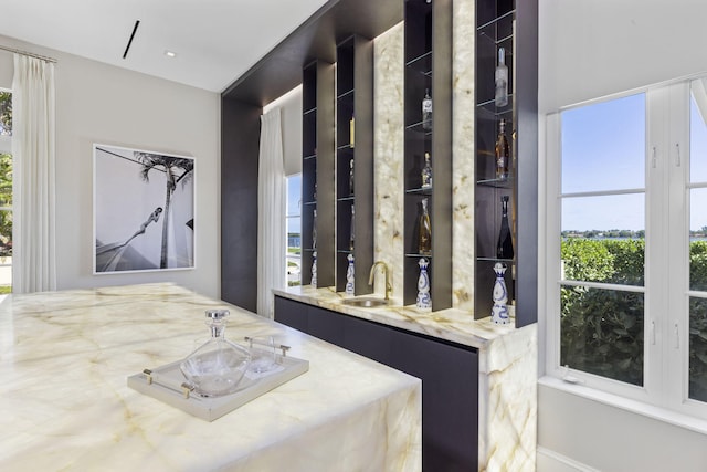 bedroom featuring wet bar and a sink