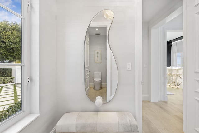 bathroom featuring hardwood / wood-style flooring and toilet