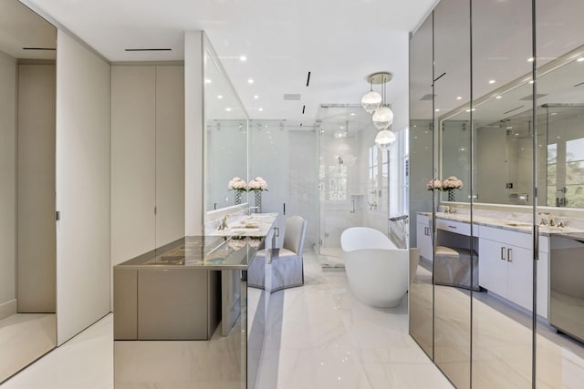 full bath featuring marble finish floor, recessed lighting, two vanities, a shower stall, and a freestanding tub