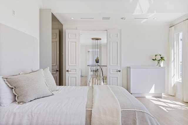 bedroom featuring multiple windows and ornamental molding