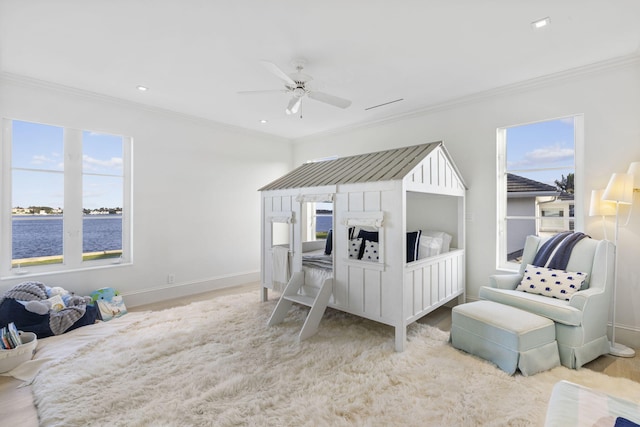 bedroom with ornamental molding, multiple windows, and baseboards