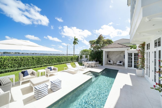 view of swimming pool with a fenced in pool, a patio area, french doors, and outdoor lounge area