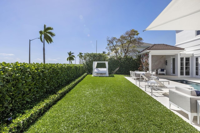 view of yard featuring an outdoor pool, outdoor lounge area, and a patio