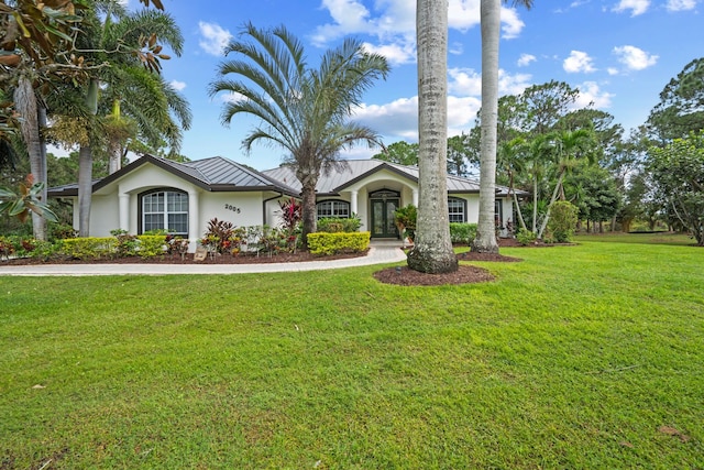 single story home featuring a front lawn