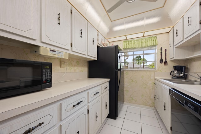 kitchen featuring white cabinetry, black appliances, light tile patterned floors, and sink