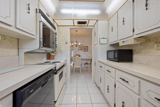 kitchen with light tile patterned flooring, white cabinetry, black appliances, an inviting chandelier, and pendant lighting