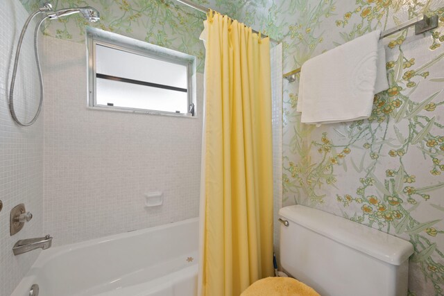 bathroom featuring toilet and shower / bath combo