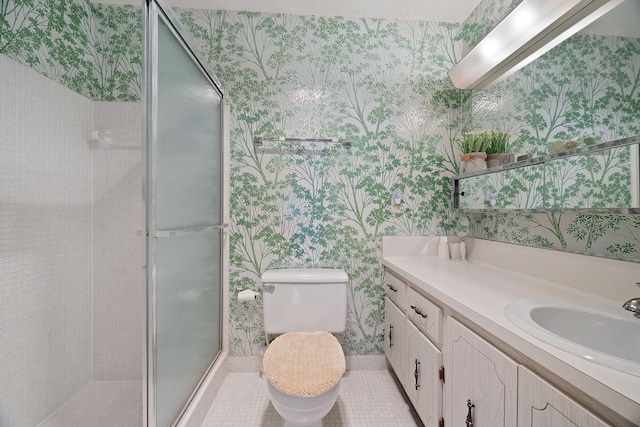 bathroom featuring tile patterned flooring, vanity, toilet, and a shower with shower door